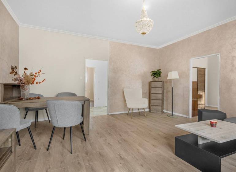 Bright living room with seating and wooden furniture in a 3-room apartment.