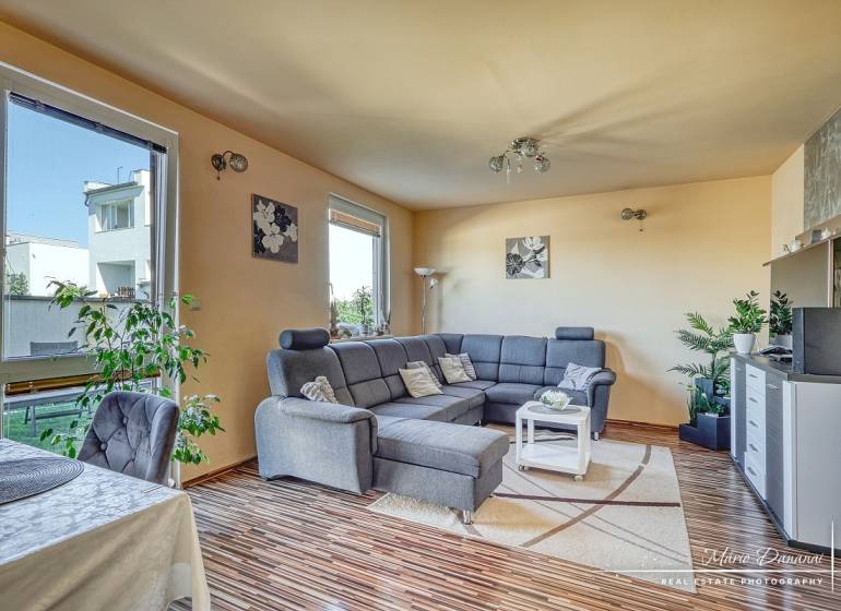 A living room in a family house with a comfortable sofa corner and a wooden decor floor.