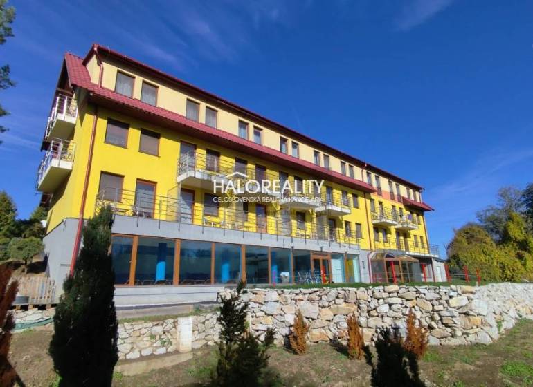 Yellow building with balconies, surrounded by greenery in Dudince, Gastro premises.