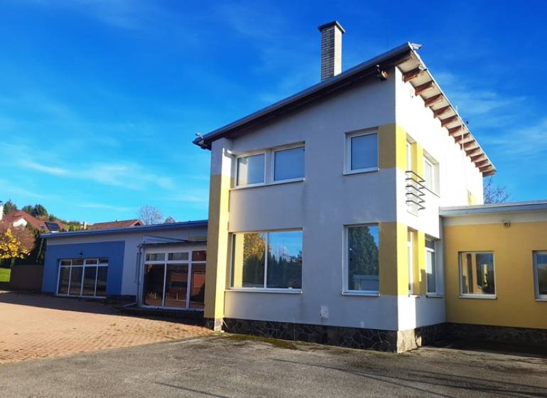 A family house in Necpaly, colorful facade, large yard, sunny bright day.