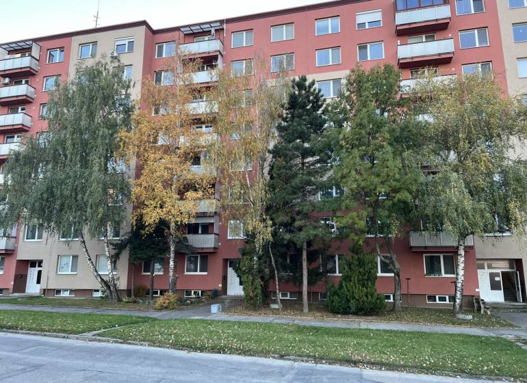 Apartment building on Hviezdoslavova Street in Senica with surrounding greenery and trees.