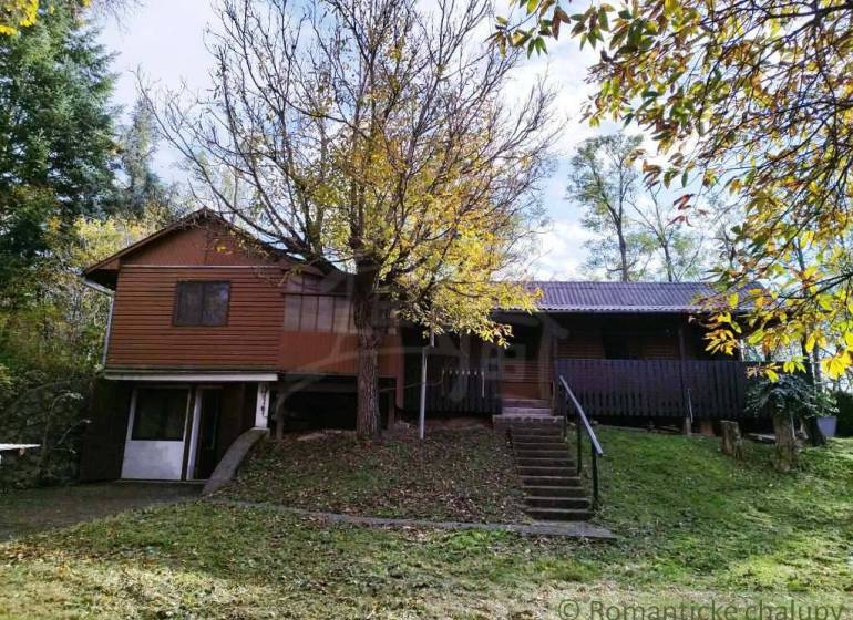 A cottage in Dudince surrounded by trees and lush greenery, ideal for relaxation.