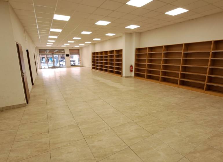 Commercial premises for rent on Mostová Street in Ružomberok, with shelves and flooring with a wooden decor.