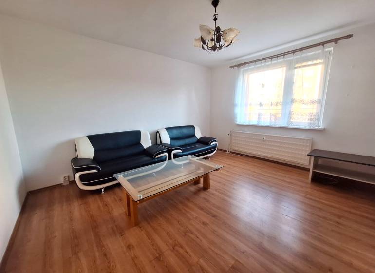 Living room in a 3-room apartment with sofas, a coffee table, and a wooden decor floor.