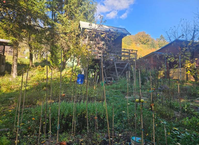 A cottage in Trenčianske Teplice on Sady pod Dedovcom street surrounded by a green garden.