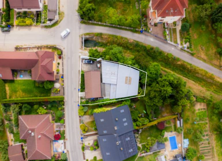 Aerial view of a family house in Trenčín on Záblatská Street, surrounded by greenery.