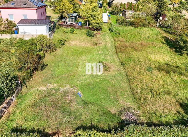 Plots - housing in Nitra with a landscaped garden and surrounding houses.