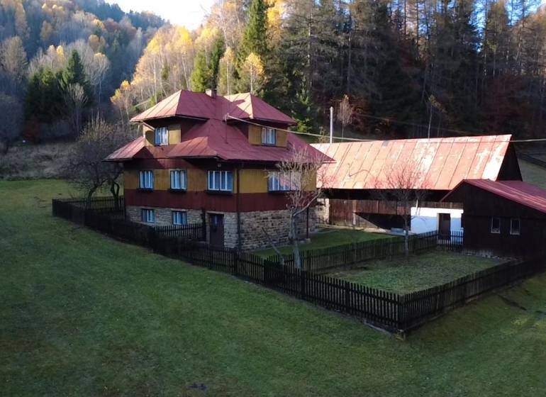 A family house in Zázrivá surrounded by forests, with stone and wooden construction.