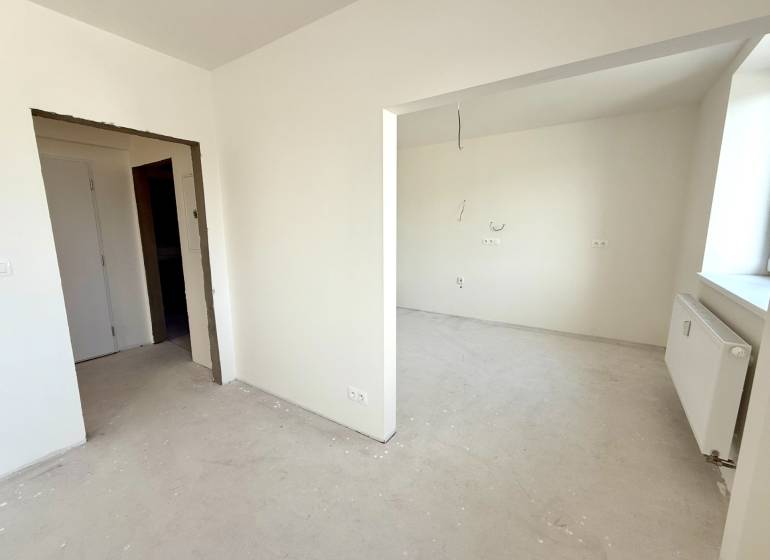 Interior of a 2-room apartment with white walls and prepared outlets for electrical installation.
