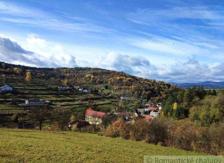 A view of picturesque gardens in Hlboké nad Váhom with a hilly landscape in the background.