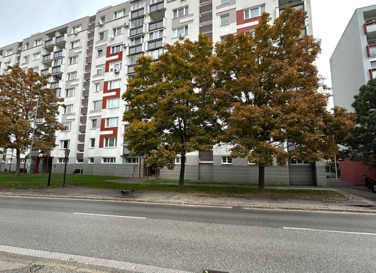 Apartment building with colorful elements and trees on Hraničná Street, Bratislava - Ružinov.