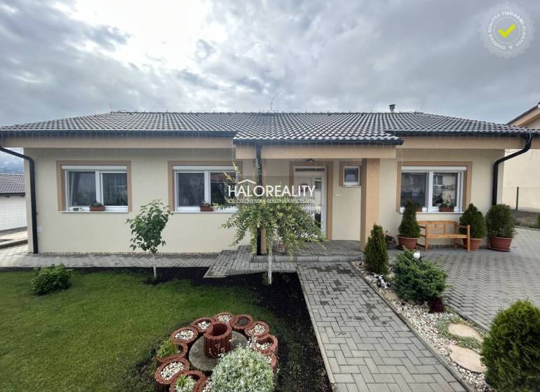 A family house in Malinová with a landscaped garden, lawn, and garden decorations.