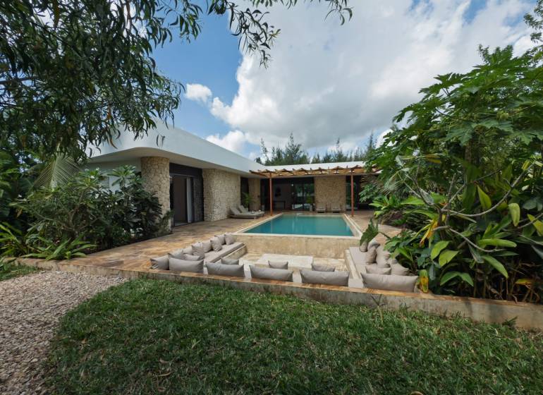 A house with a swimming pool surrounded by greenery on Paje Street in the Unguja South Region.