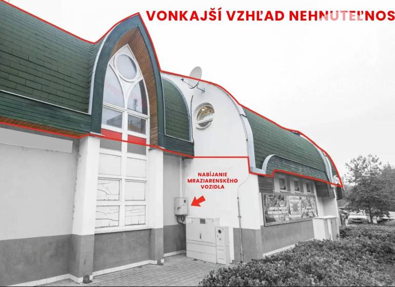 Exterior of commercial premises in Komárno with an interesting roof and modern windows.