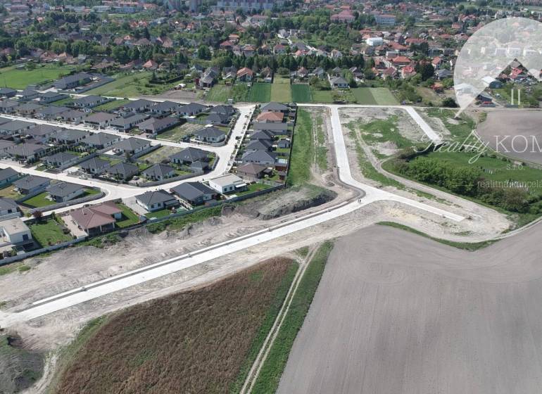 Aerial view of plots - housing in Veľký Meder with new buildings and surrounding landscape.