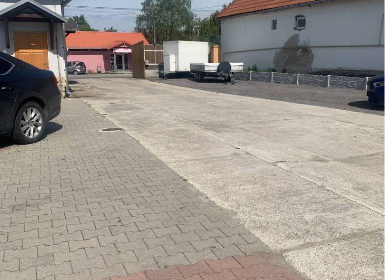 Asphalt road and buildings on Hlavná Street in Chotín, area Warehouses and Halls.