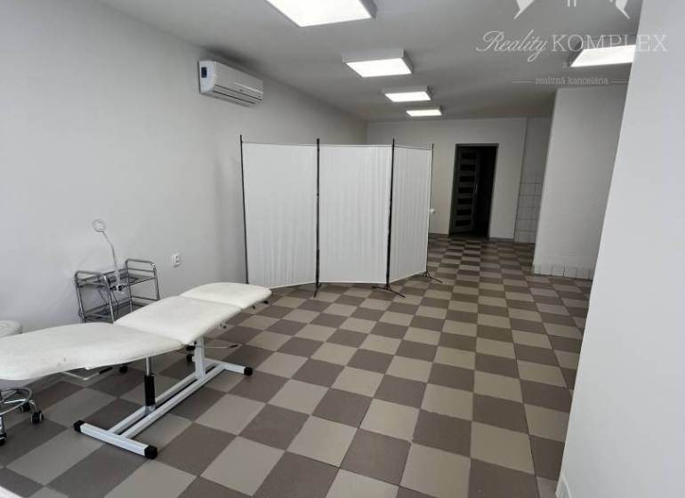 Office spaces with tiles and ceiling lights.