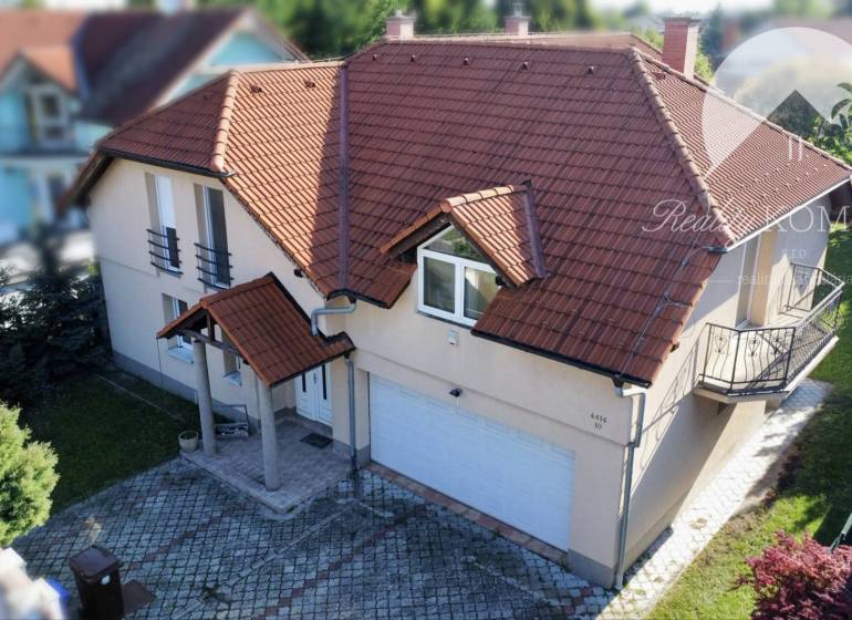 A family house in Dunajská Streda with a red roof, a small balcony, and a garage.