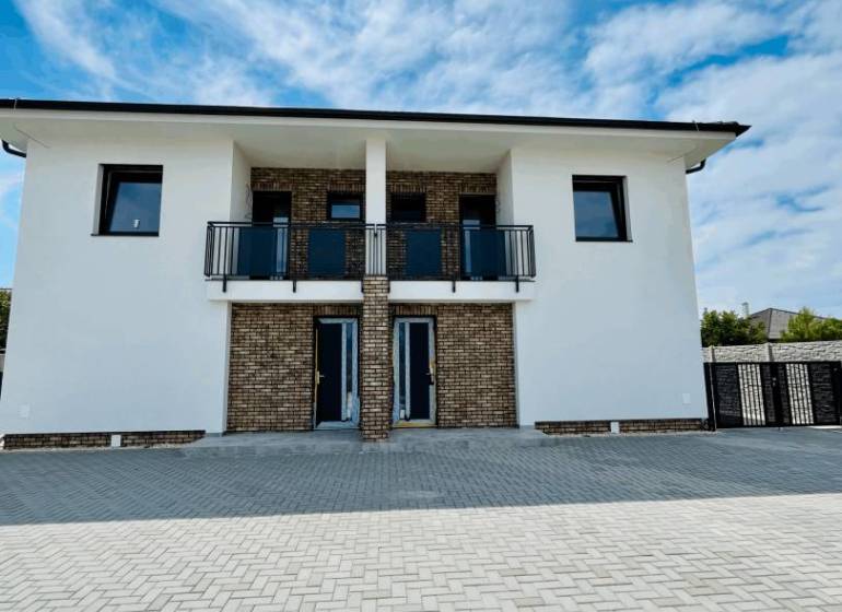 The exterior of a family house in the town of Veľký Meder with a paved access area.