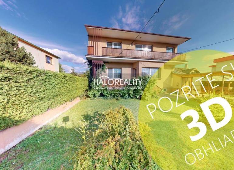 A family house in Krasňany with a front garden and a green hedge.