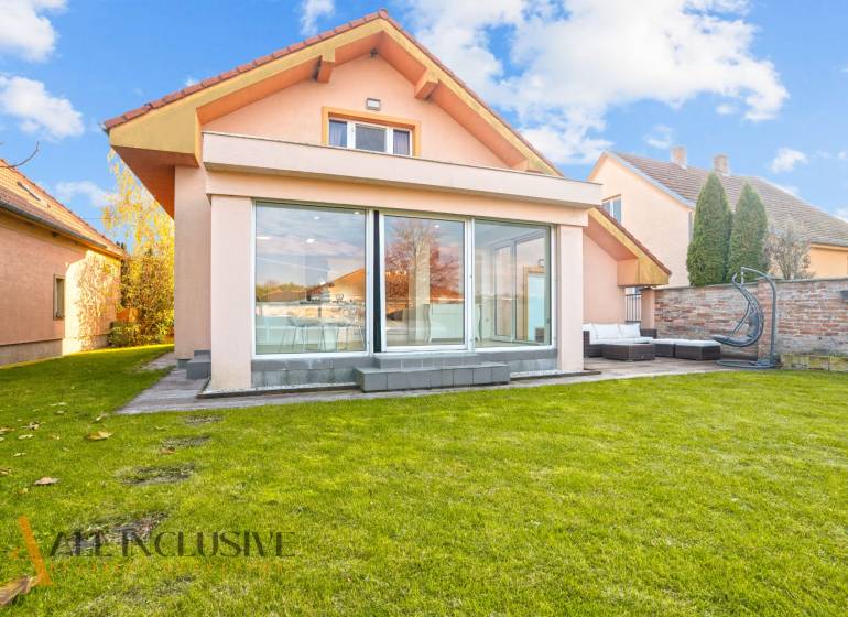 A family house in Dobrohošť with a spacious green garden and a glass terrace.