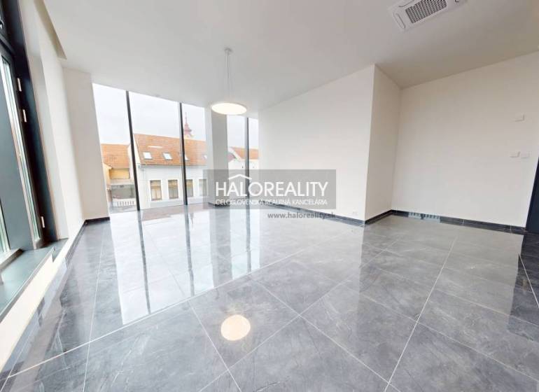 Spacious offices with large windows and ceramic tile flooring.