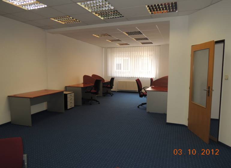 Offices with carpeted floors, desks, and swivel chairs.