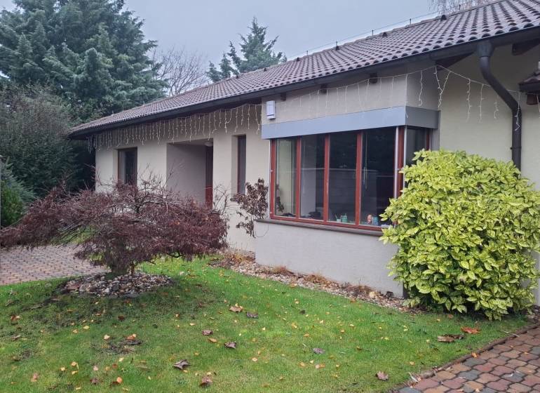 A family house in Bohdanovce nad Trnavou with a landscaped garden and winter decorations.
