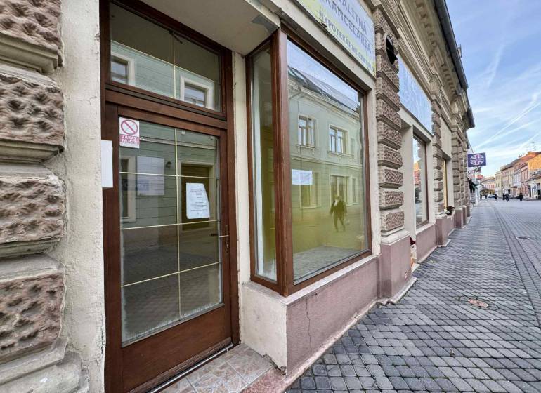 The exterior of commercial premises on Župná Street in Komárno with glass doors.
