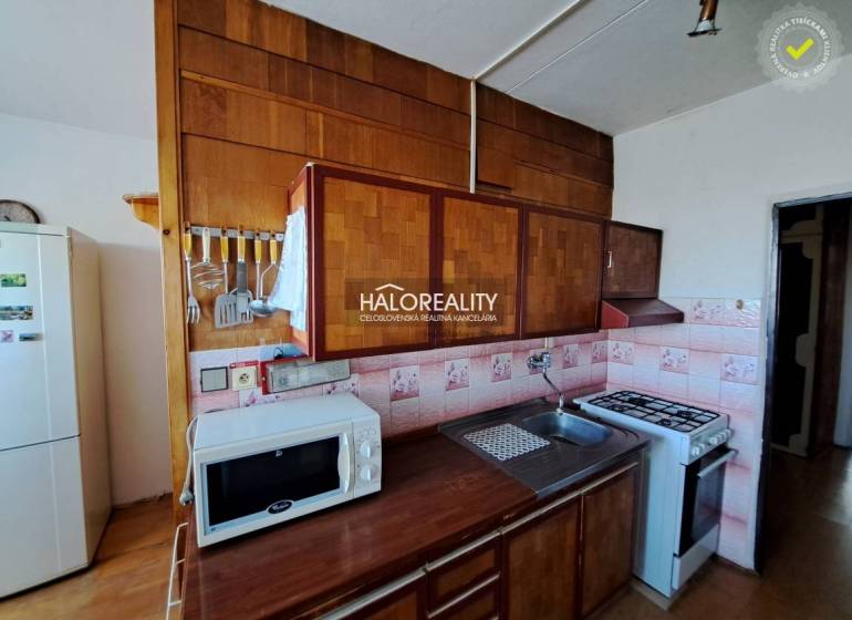 Living room in a 3-room apartment with sofas, wood-patterned flooring, and large windows.