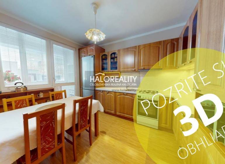 A kitchen in a 2-room apartment with a light wood decor and a dining table.