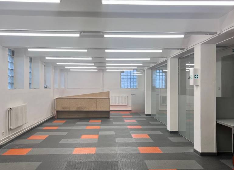 Commercial premises with a colorful floor and glass partitions, suitable for offices or operations.