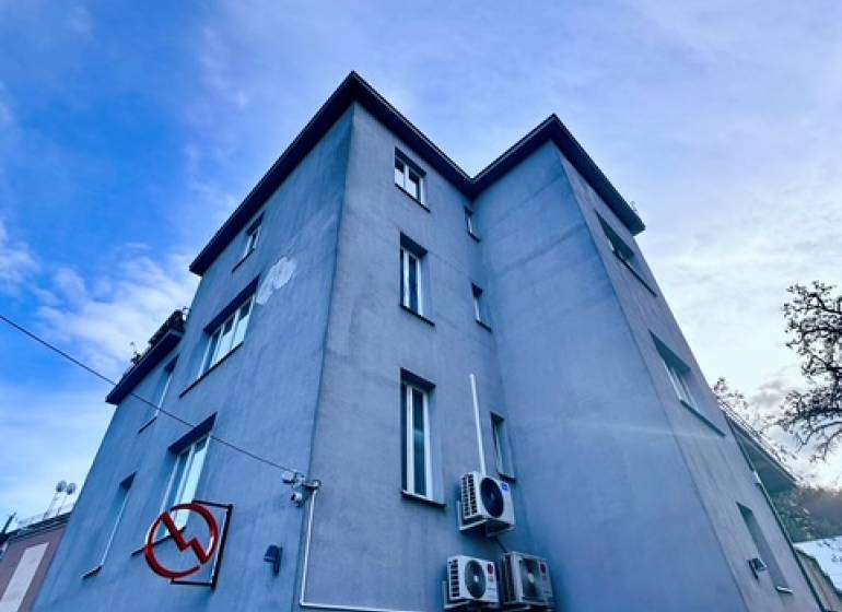 An office building on M.R. Štefánik Street in Trenčín under the blue sky.