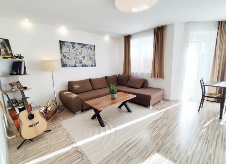 Living room in a family house with a large sofa and a floor with a wooden decor.