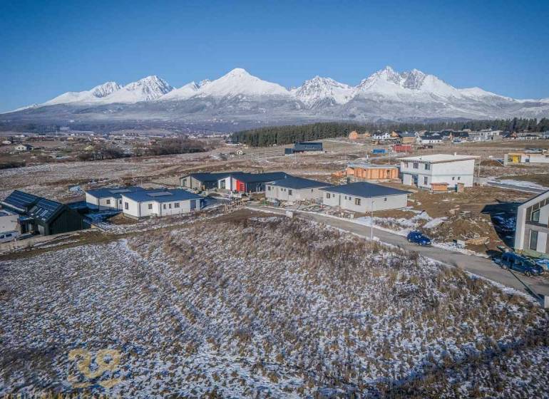 Snow-covered residential plots in Mlynica with panoramic mountain views.