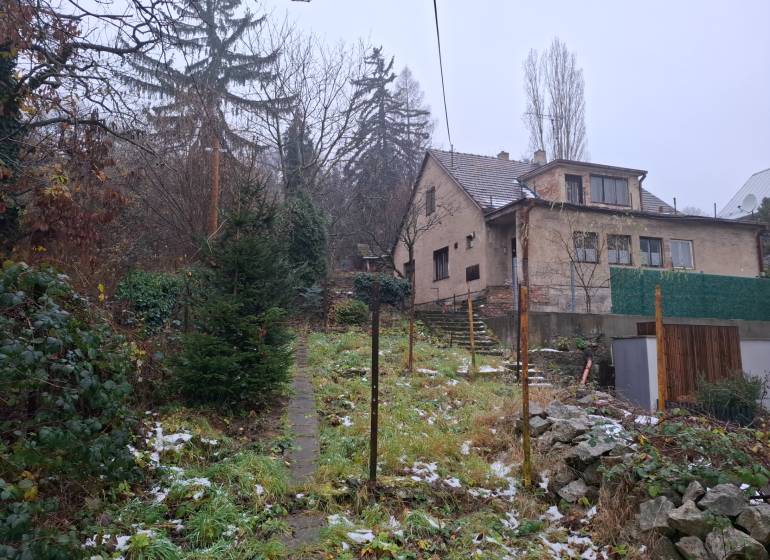 A family house on Búdková Street in Bratislava - Staré Mesto, surrounded by a snowy garden.