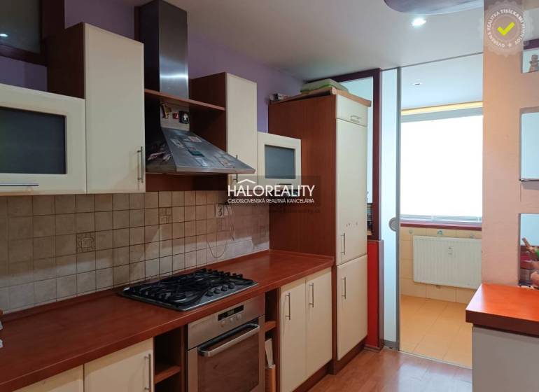 A studio apartment kitchen with a gas stove and glass cabinets.