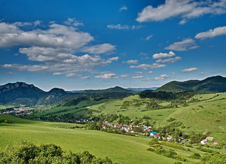 Beautiful landscape around Lechnice with agricultural and forest lands under the blue sky.