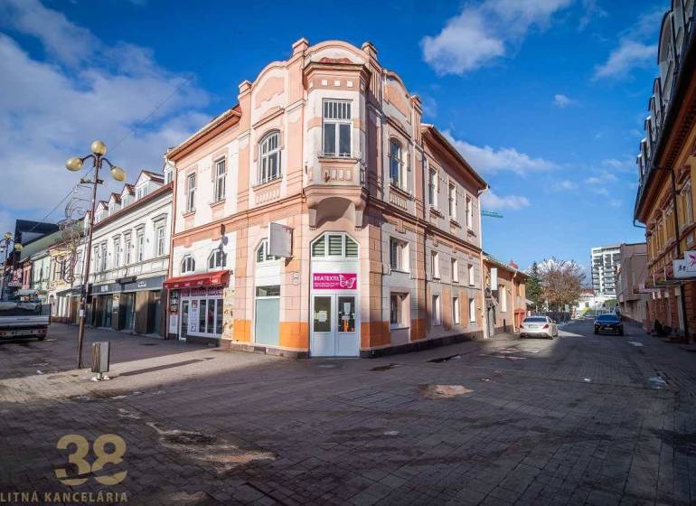 A historic building in Poprad with decorative architectural elements on the corner of the street.