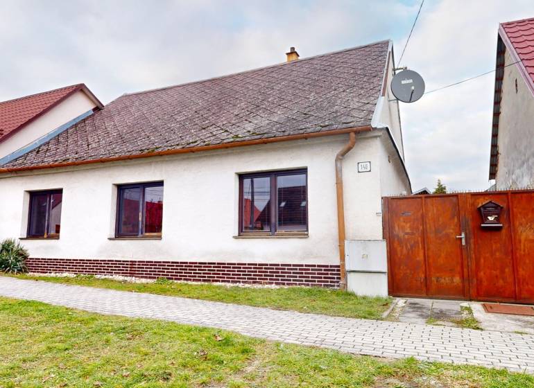 A family house on SNP Street in Veľké Leváre, with a white facade and a gabled roof.
