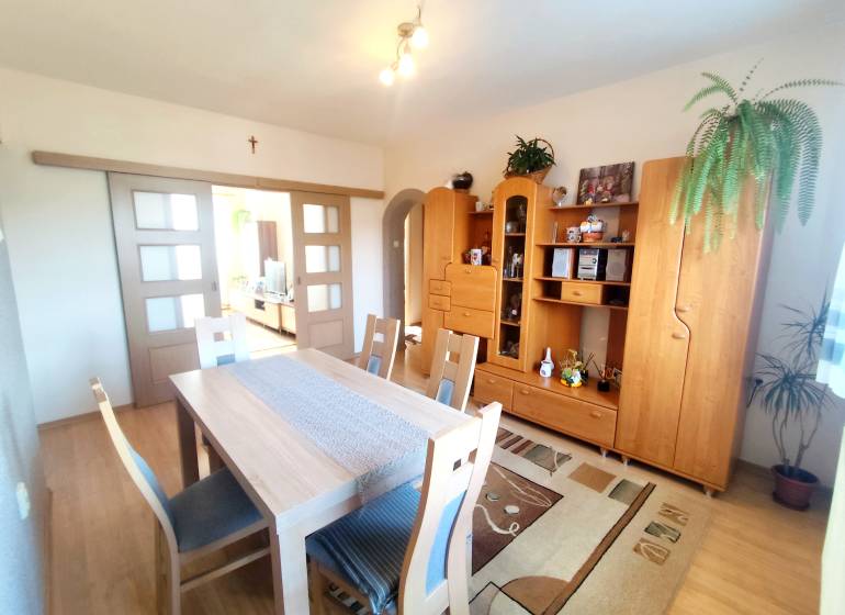 Interior of a 3-room apartment with wooden furniture and flooring with a wooden decor.