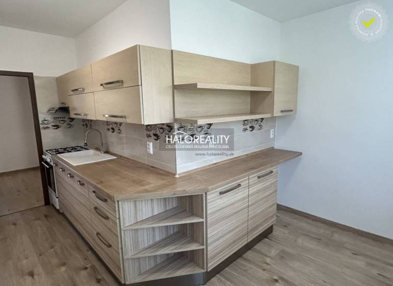 A kitchen with light wood and decor in a 3-room apartment.