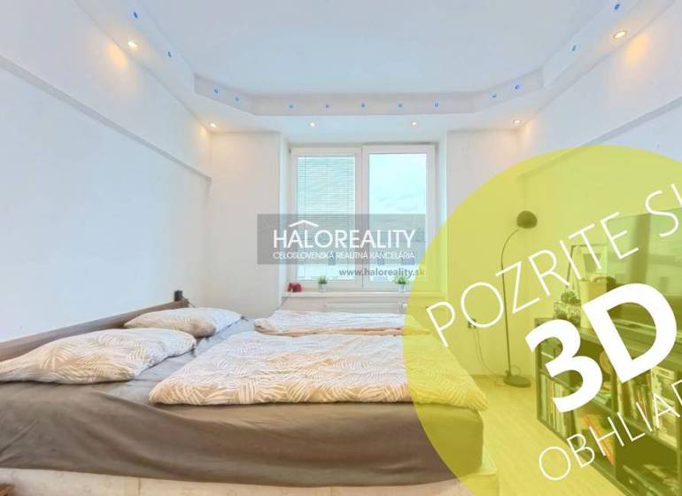 Bedroom in a 2-room apartment with a double bed and a large window.
