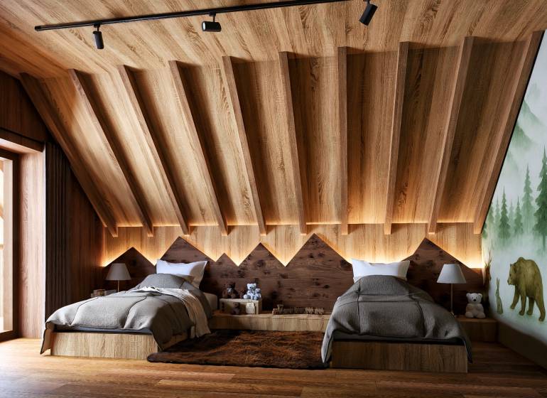 Attic bedroom with two beds, wooden decor, and a forest motif on the wall.