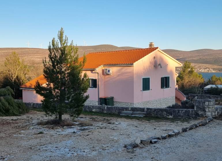 A family house in Pridraga near the coast, surrounded by nature and countryside with wind turbines.