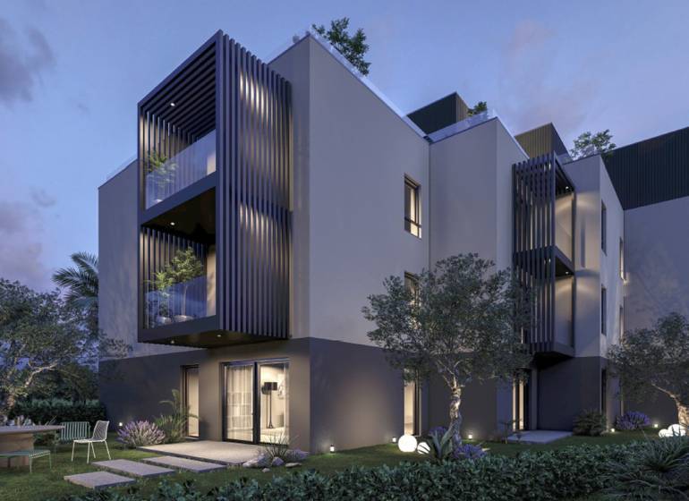 Exterior of a holiday apartment in the town of Hvar with a garden and terrace at sunset.