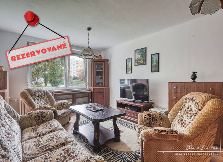Living room with furniture in a 3-room apartment and a carpet. Reserved.