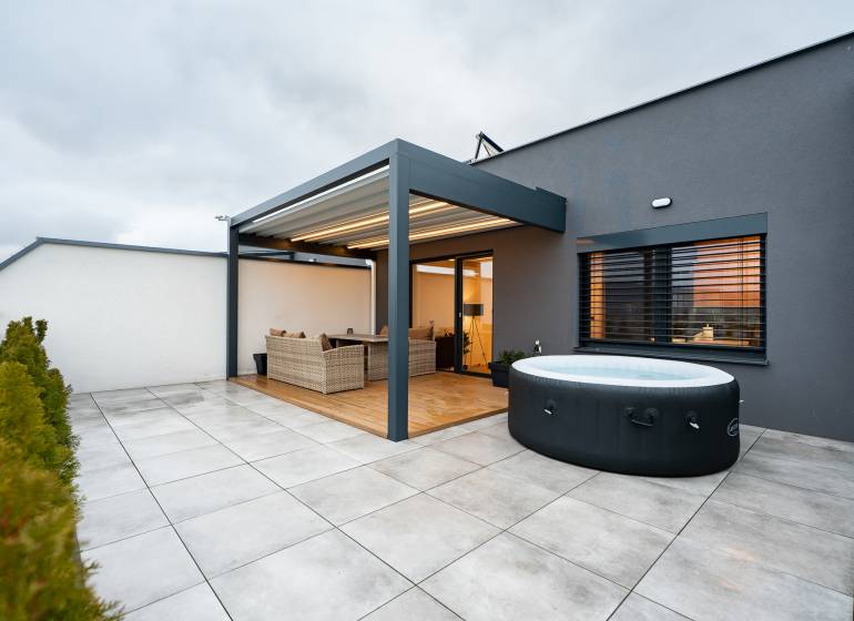 Terrace of a 3-room apartment with a hot tub and rattan furniture, Kožušnícka Street in Trenčín.