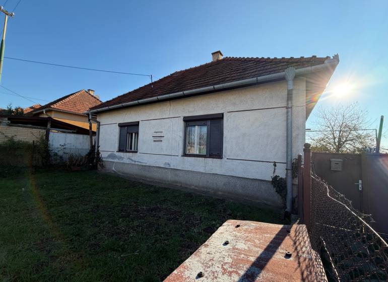 A family house on the main street in Súlovce with a white facade and a gabled roof.