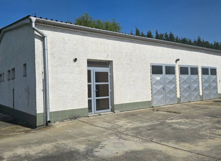 A white building with metal doors in the warehouse and hall zone of the city of Šaľa.